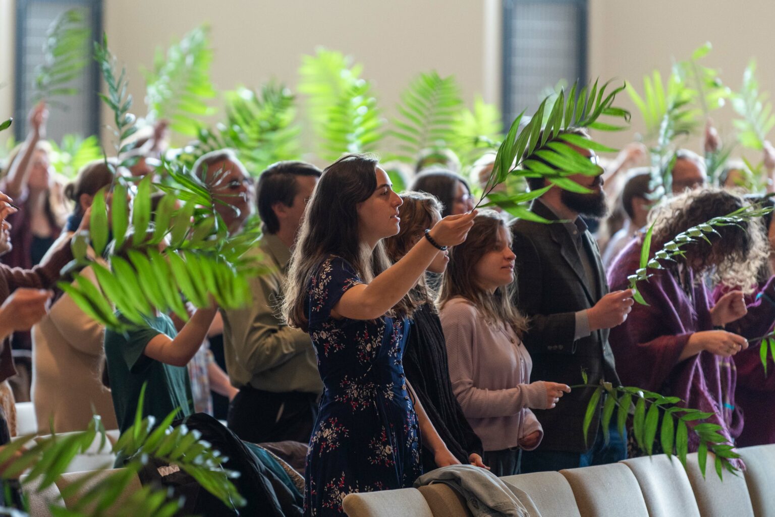 The congregation worshipping with palm branches on Palm Sunday at Church of the Resurrection